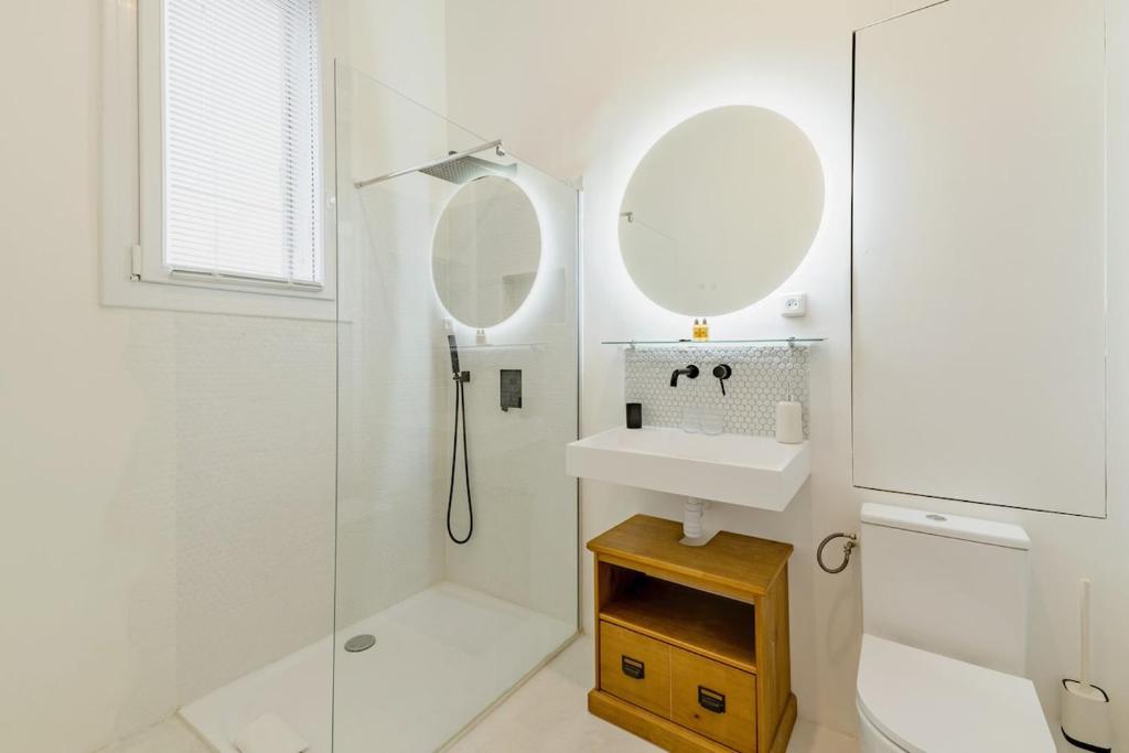 a white bathroom with a sink and a mirror at |Aaa|- Pure &amp; Natural Massilia City Center in Marseille