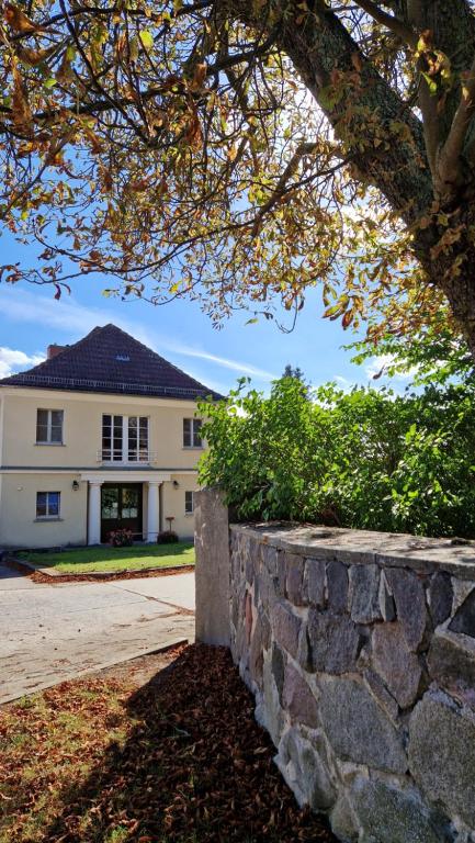 a stone wall in front of a building at Gästehaus Wilsickow in Lübbenow
