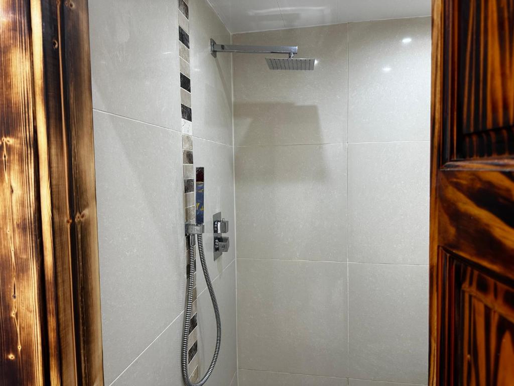 a shower in a bathroom with a glass door at Happy holiday in Birmingham