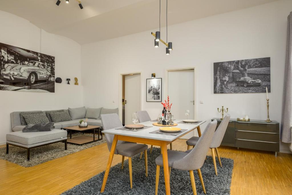 a dining room and living room with a table and chairs at SweetHome - Luxus pur - große Küche, Terrasse, Stellplatz, WiFi in Halle an der Saale