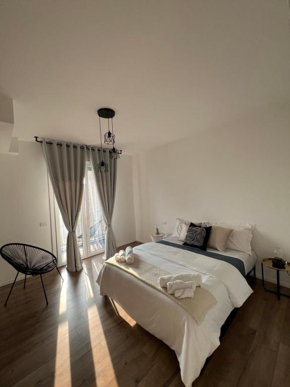 Hotel Appartamento Business Milano, a white bedroom with a large bed and a window at Appartamento Business Milano in Milan