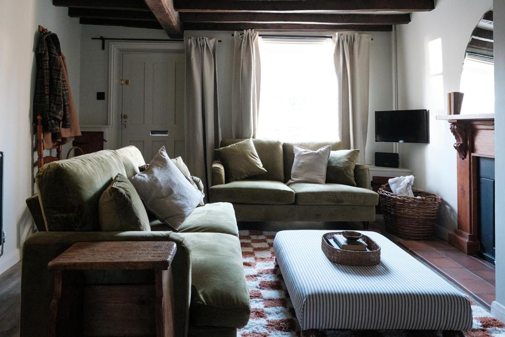a living room with a couch and a table at Luxury family and dog friendly cottage in North Norfolk, Aylsham in Aylsham