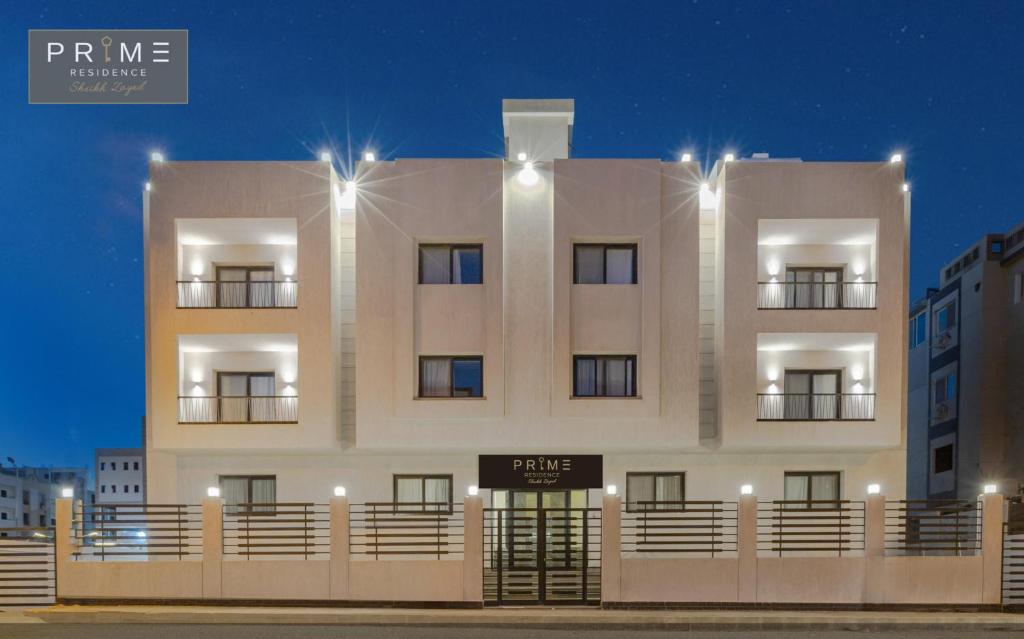 a white building with lights on top of it at Prime Residence Sheikh Zayed in Sheikh Zayed