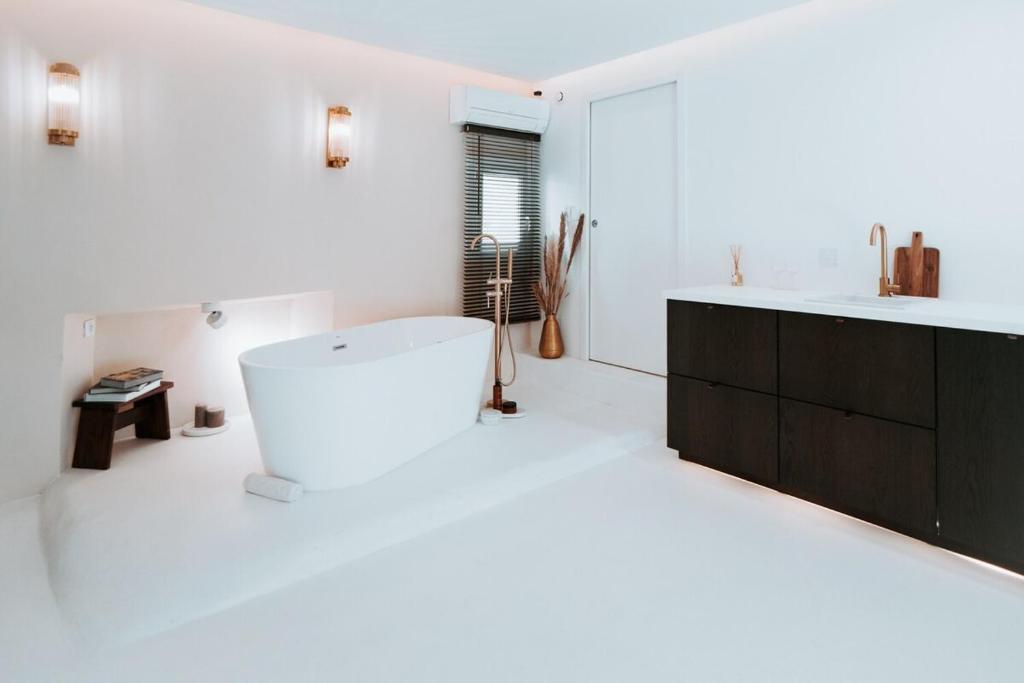 a white bathroom with a sink and a white counter at Love & Balneo Week-End in Marseille