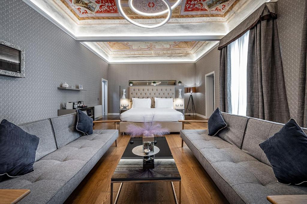 a hotel room with a couch and a bed at Martelli 6 Suite & Apartments in Florence