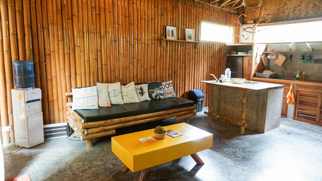 a living room with a couch and a table at Happiness Vacation Villa El Nido in El Nido