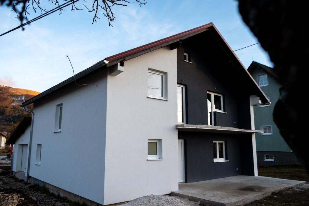 dom z czarno-białą fasadą w obiekcie Kuca za odmor Nedo w mieście Kupres