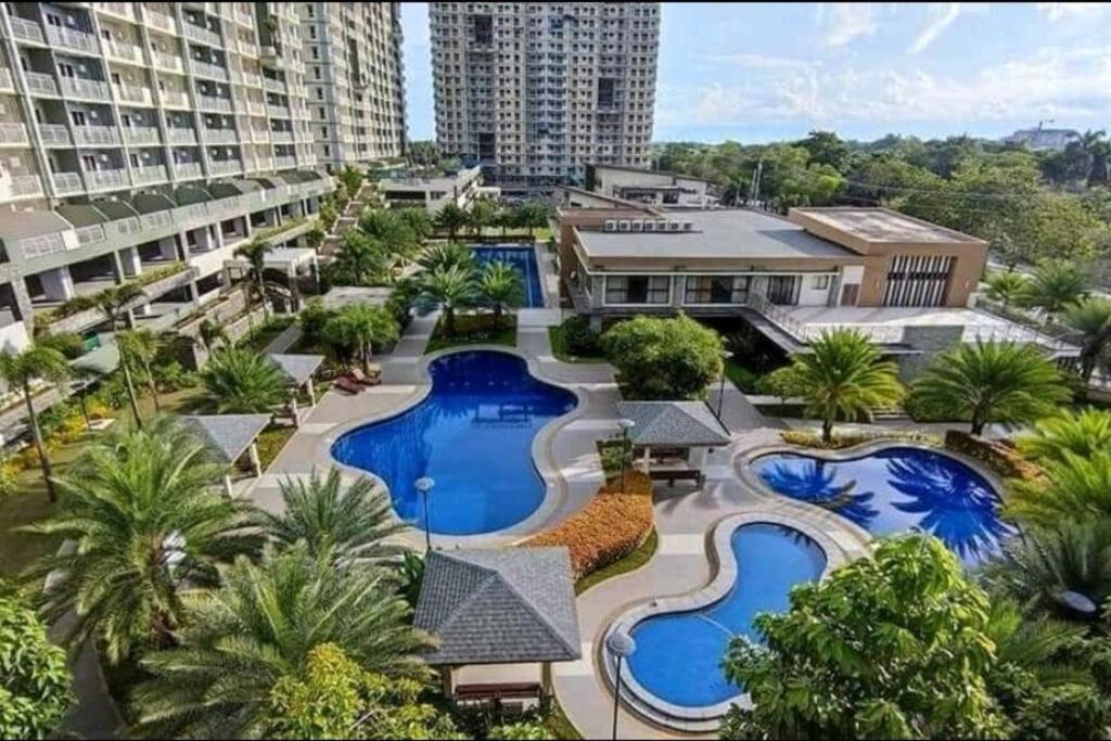 an aerial view of a resort with two pools at Verdon Parc 2Br Comfy Resort facing Samal island! in Davao City