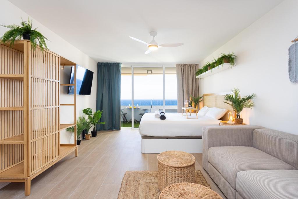 a hotel room with a bed and a couch at Butan Suite in Callao Salvaje