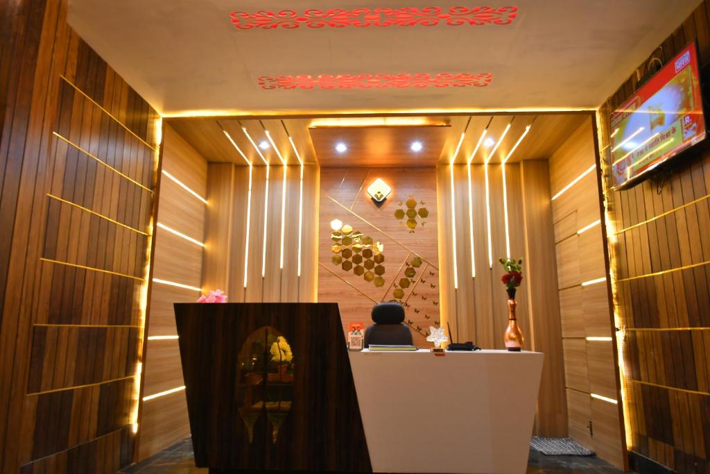 a lobby with a reception desk in a building at Paradise Inn in Jasidih