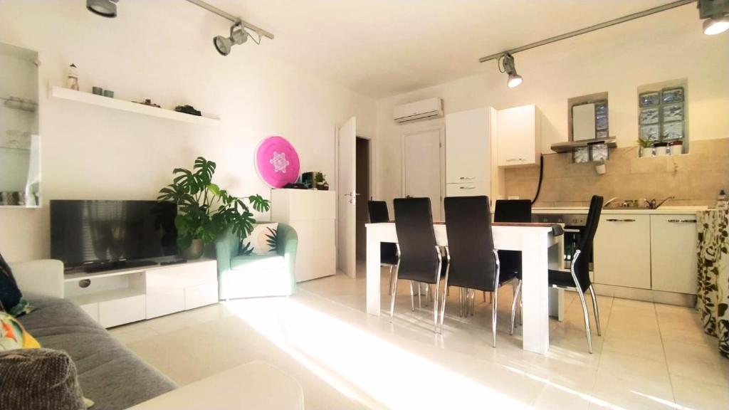 a kitchen and living room with a table and chairs at Leo's Villa in Milano Marittima