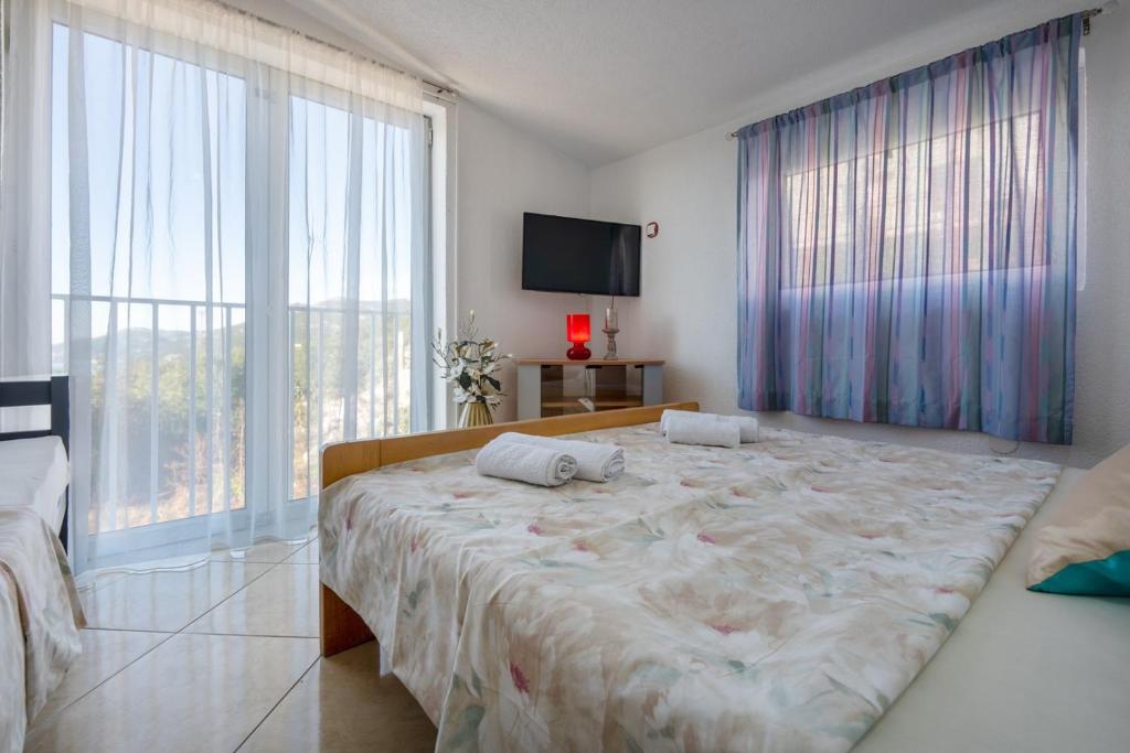 Postel nebo postele na pokoji v ubytování Apartments Vrabac