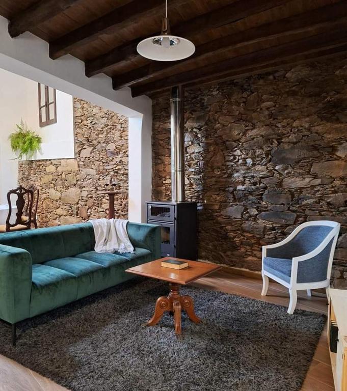 a living room with a couch and a table at Porta 28 in Penacova