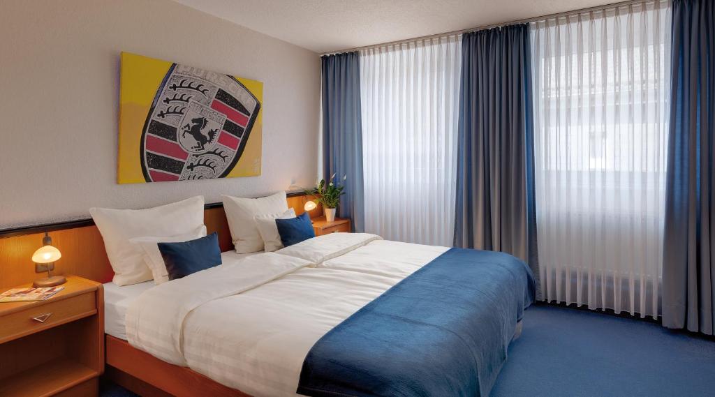 Postel nebo postele na pokoji v ubytování Motorsport Hotel