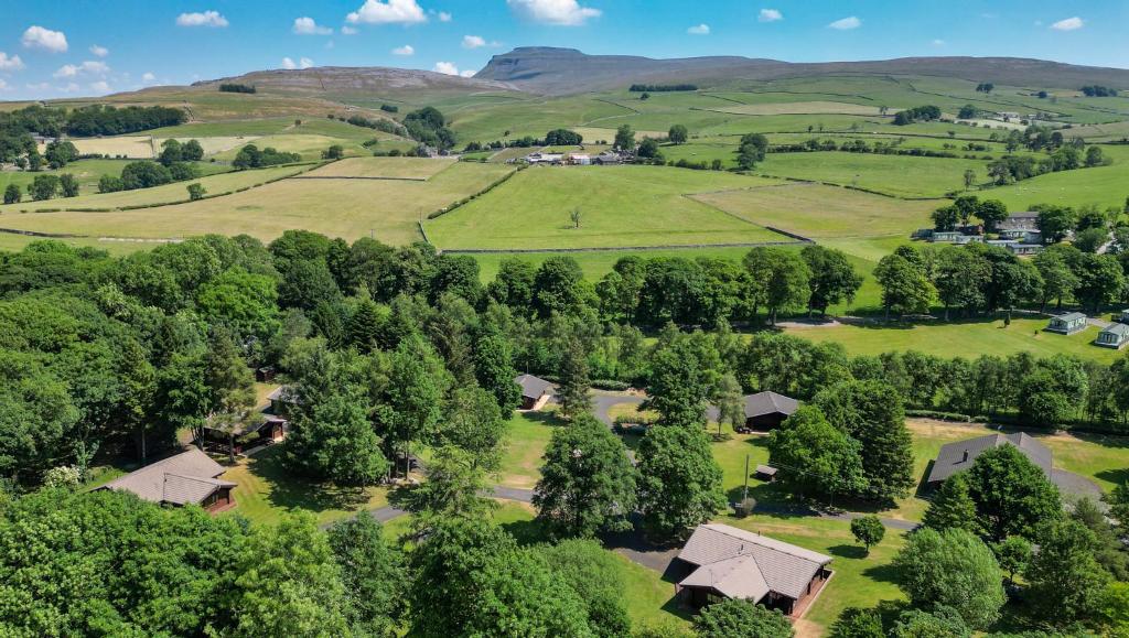 an aerial view of a farm with trees and houses at Pinecroft Lodges in Ingleton 