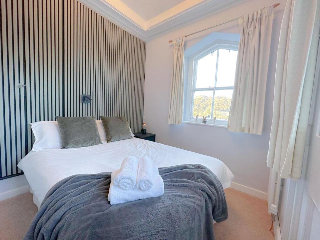 a bedroom with a bed with towels on it at 4 Studio House Ambleside in Ambleside