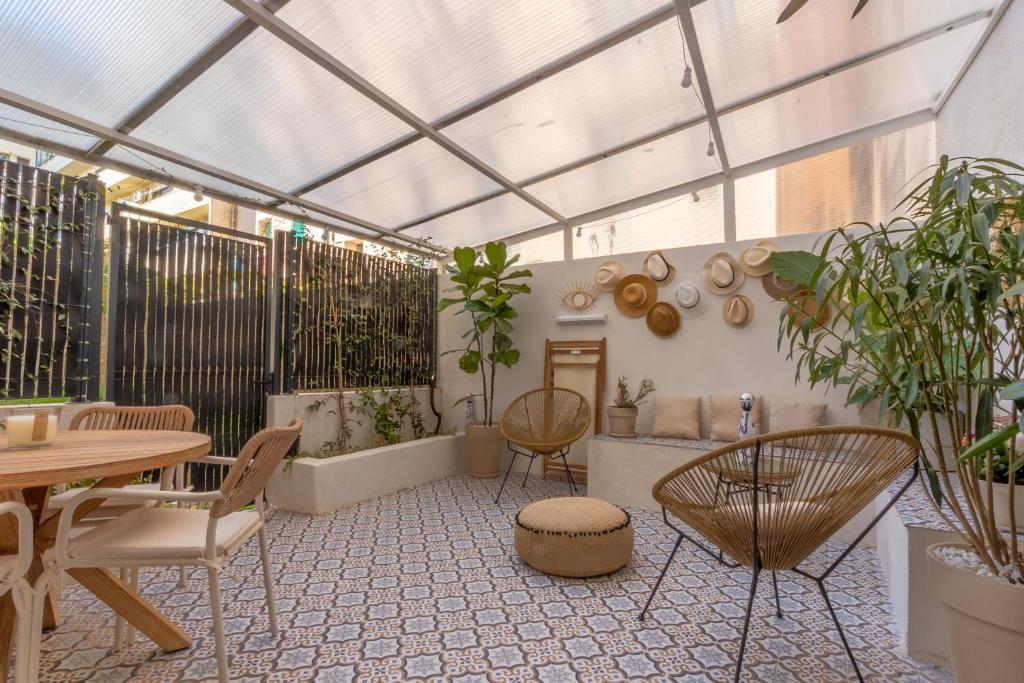 invernadero con mesa, sillas y plantas en Le Miot - Duplex avec terrasse, en Ajaccio