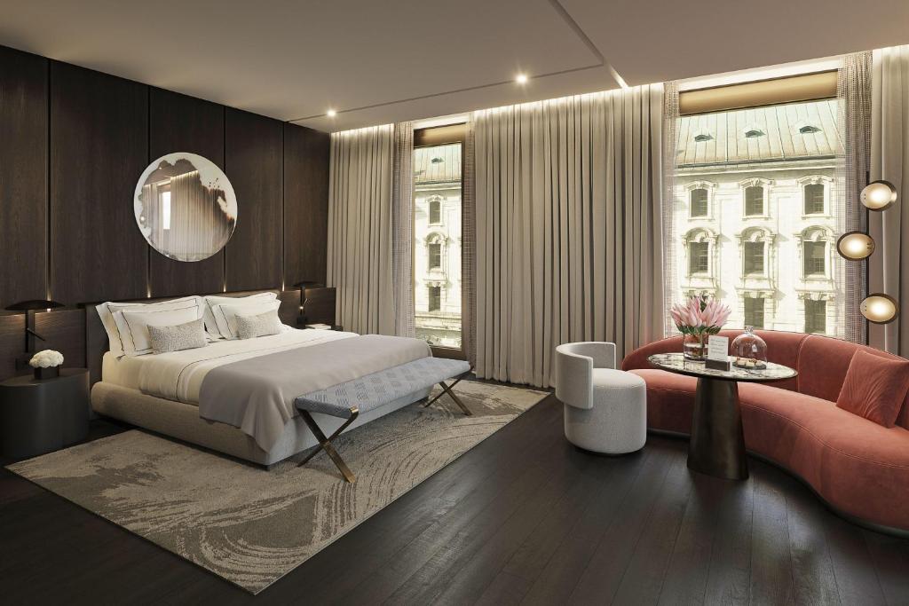 a bedroom with a bed and a large window at Koenigshof, a Luxury Collection Hotel, Munich in Munich