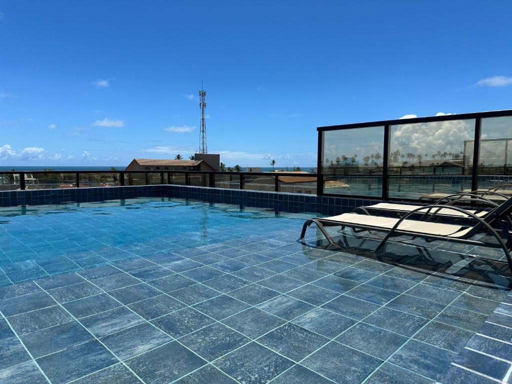 a swimming pool on the roof of a building at Pousada Atlantic in Porto De Galinhas