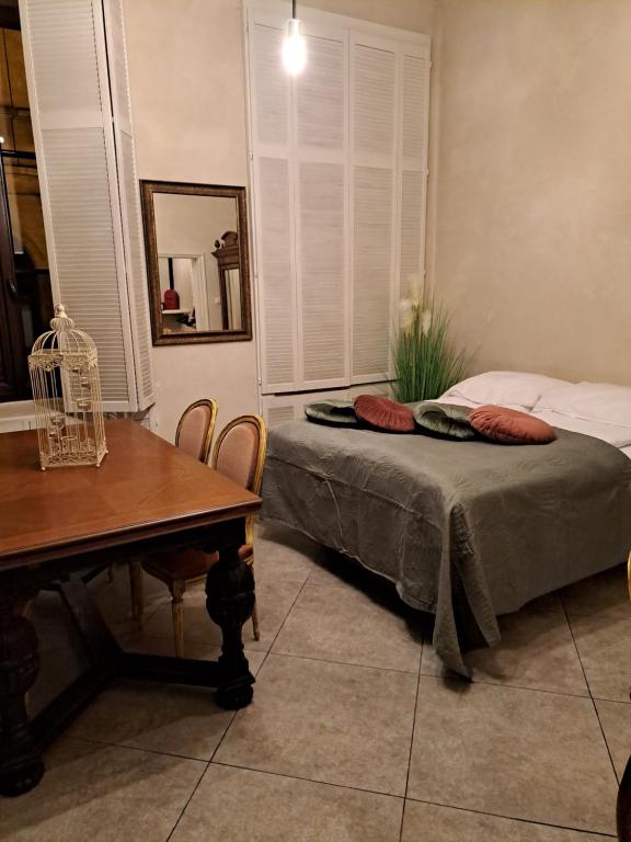 ザモシチにあるPokoje na Starówceのベッドルーム1室(ベッド1台、テーブル、テーブル、椅子付)
