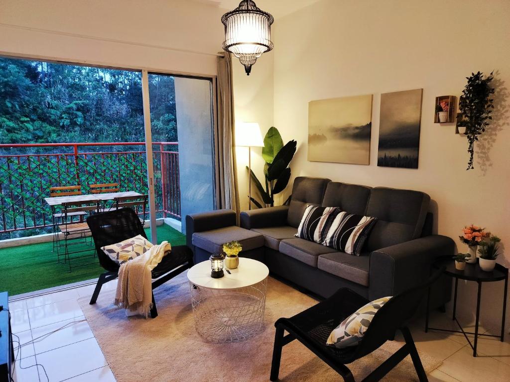 a living room with a couch and a table at Emerald Avenue Brinchang 8 guests 3 bedrooms in Brinchang