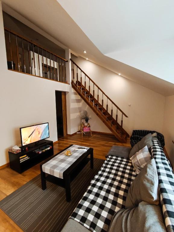 a living room with a couch and a table at Kora in Sosnowiec