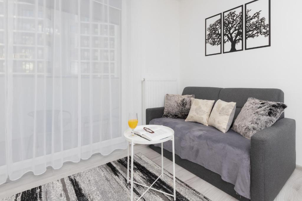 a living room with a couch and a table at Cozy Apartment Gdańsk Morena Rakoczego by Rent like home in Gdańsk
