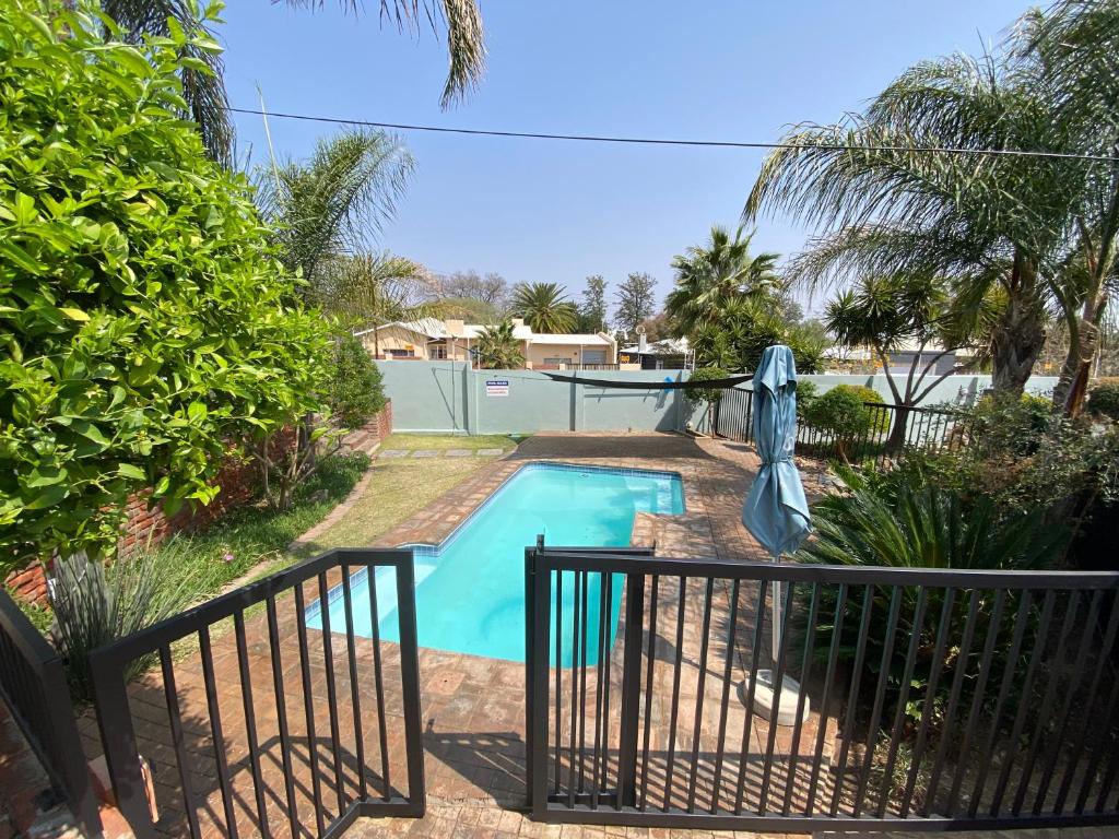 a swimming pool with a slide in a yard at Nambani House in Windhoek