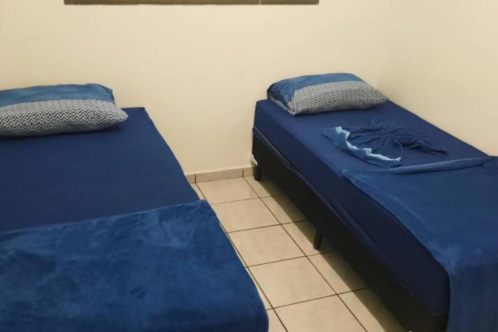 two beds sitting next to each other in a room at Chalé 17 in Campo Grande