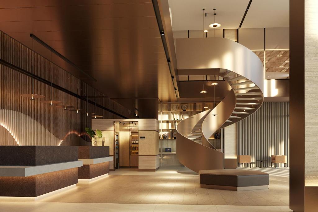 a lobby with a spiral staircase in a building at Residence Inn by Marriott Santiago de los Caballeros in Santiago de los Caballeros