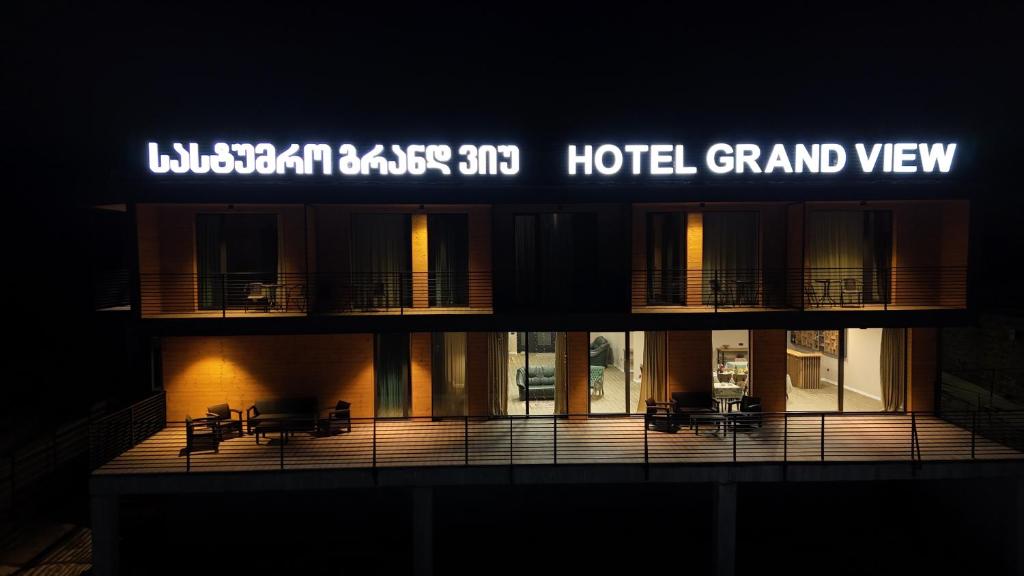 a building with a hotel grand view at night at Hotel Grand View in Stepantsminda