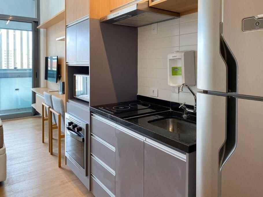 a kitchen with a stainless steel refrigerator and a sink at Apt. inteiro recém-reformado - Vila Mariana in São Paulo