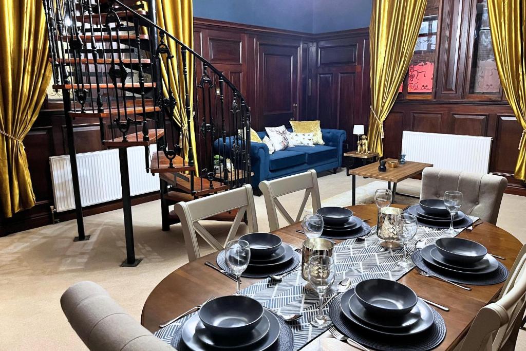 a dining room with a table with plates and hats on it at The Old Brewery Boardroom - Winchester City Centre, Free Parking for 2 Cars, Sleeps 6 in Winchester