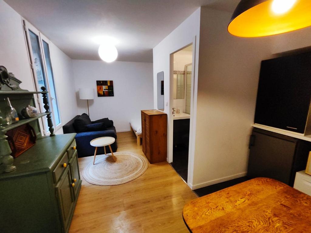 a living room with a couch and a table at Charming apartment downtown Bordeaux in Bordeaux