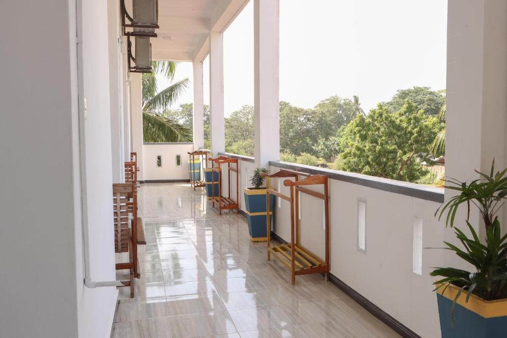 an empty hallway with large windows in a building at Chimaca Bay Hotel in Arugam Bay