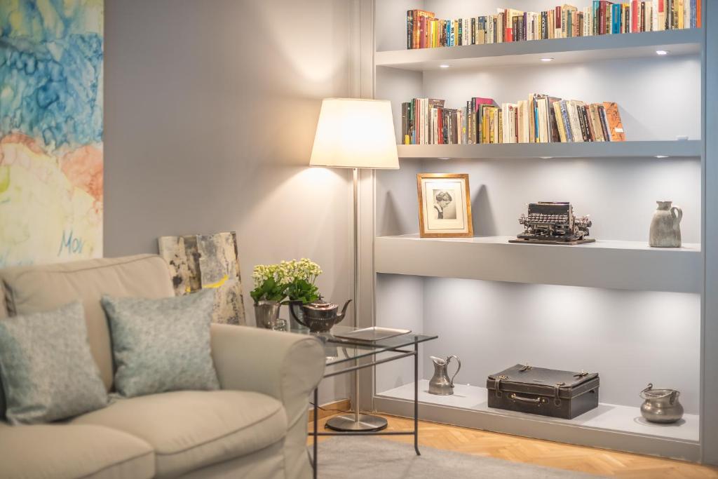 a living room with a couch and a table with a lamp at Luxurious apartment in Kolonaki in Athens