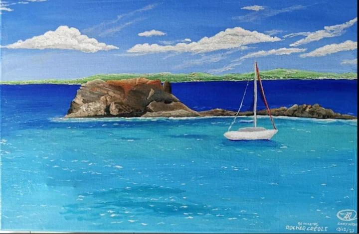 a sail boat in the water with a small island at Chez Anne - Grand Caz in Marigot