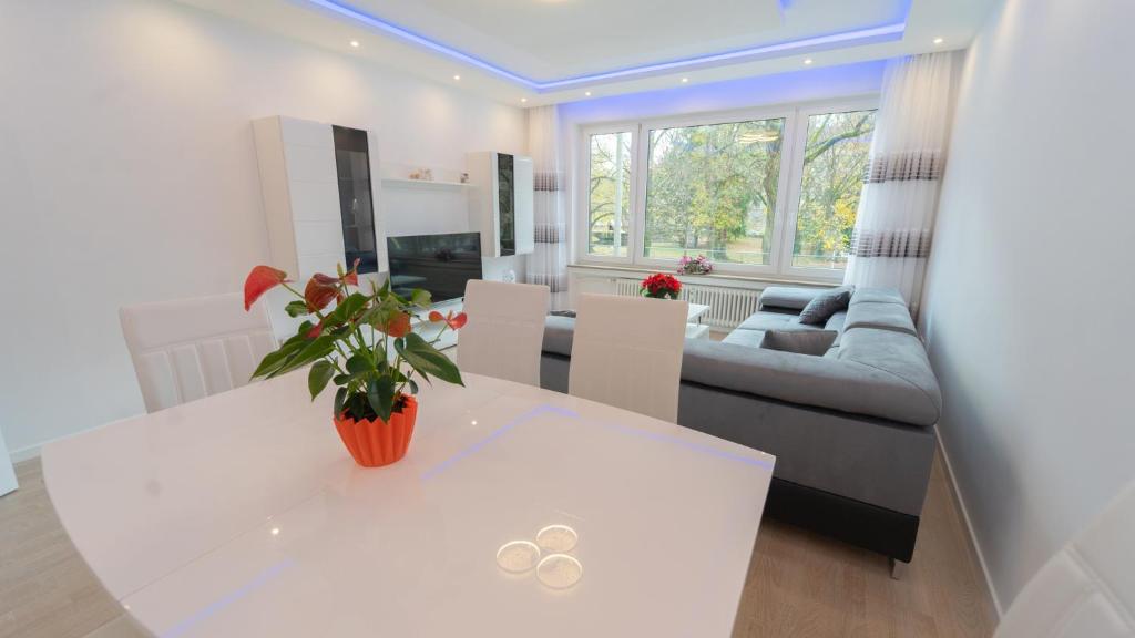 a living room with a white table and a couch at Mega Lux Apartment in Esslingen