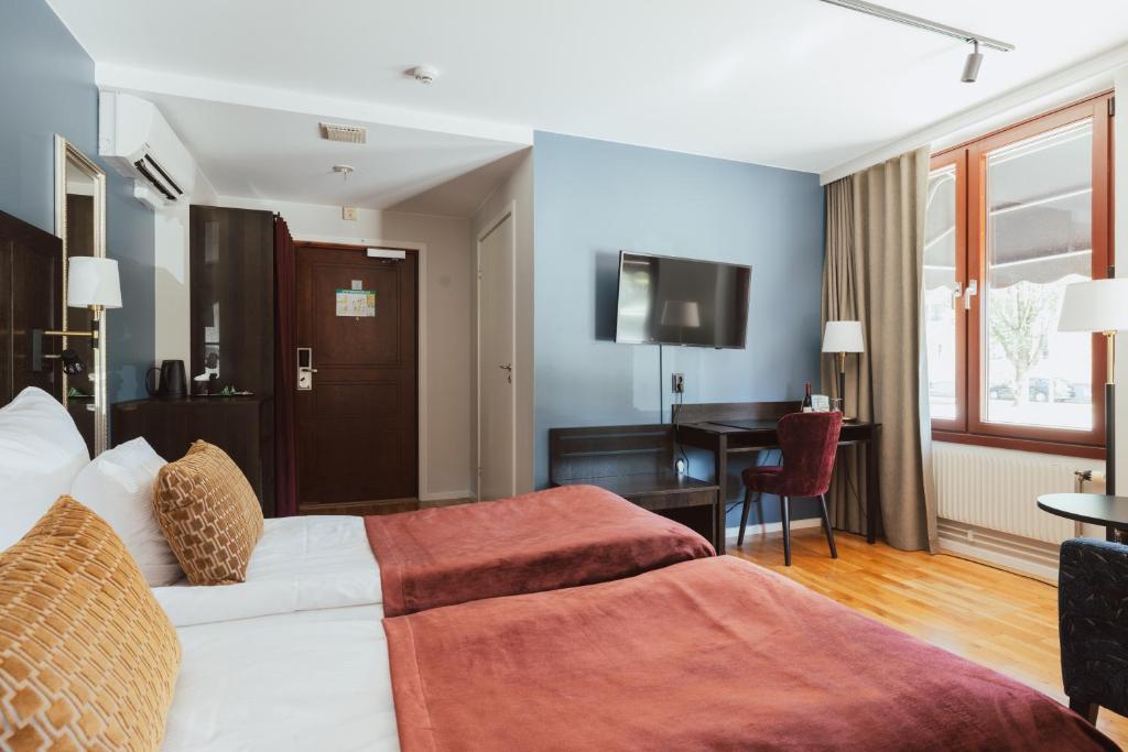 Postel nebo postele na pokoji v ubytování Home Hotel Kung Oscar