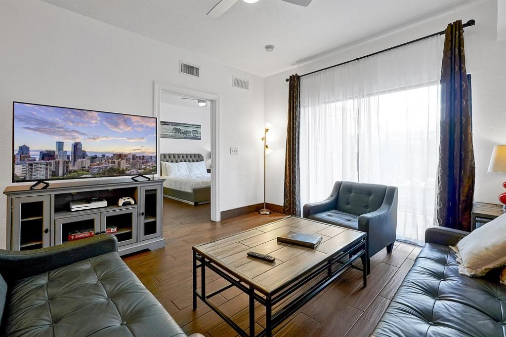 a living room with a couch and a table at International Drive Luxury Condo in Orlando