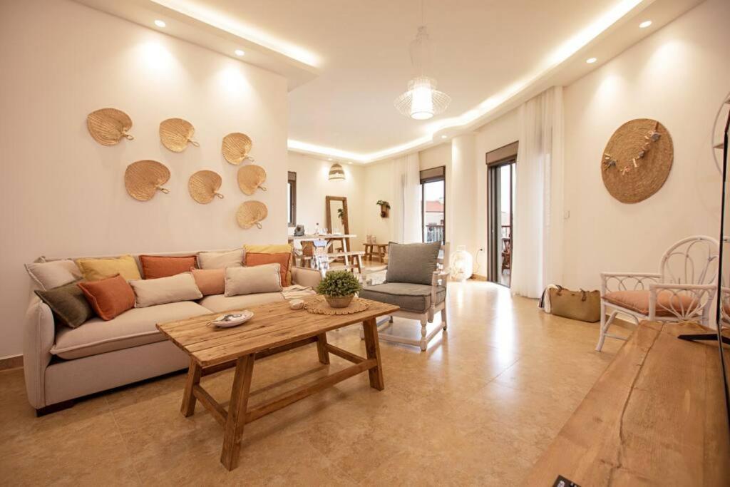 a living room with a couch and a table at Delmare 3BR Apartment in Batroun in Batroûn