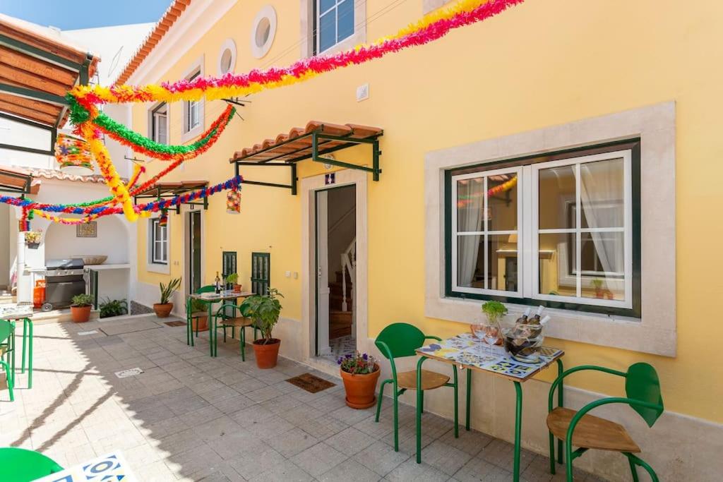 a patio with tables and chairs and a building at Mouraria Lisbon Soul Apartments T1 - 4 pax in Lisbon