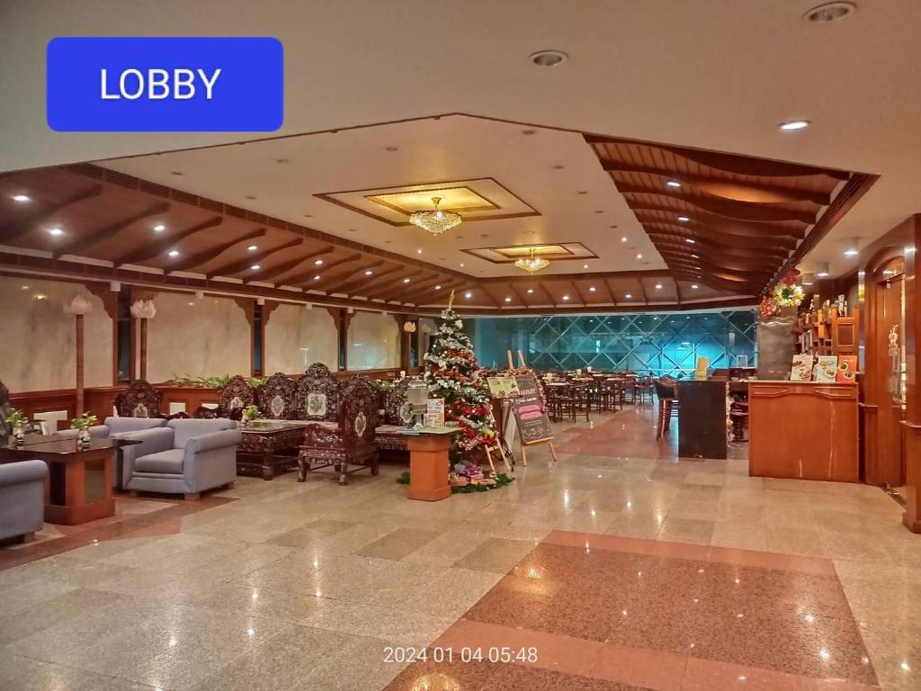 a lobby with a christmas tree in the middle at MIKE HOTEL - Walking Street Pattaya in Pattaya Central