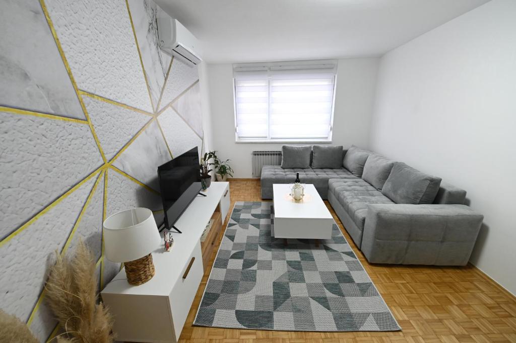 a living room with a couch and a table at Apartman N&D in Banja Luka