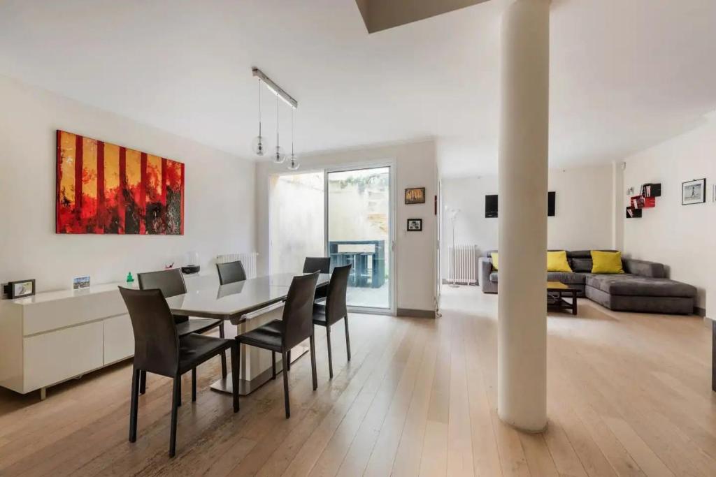 a dining room and living room with a table and chairs at Family house Bordeaux in Bordeaux