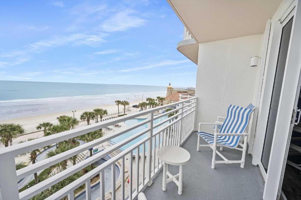 a balcony with two chairs and a view of the beach at Luxury 6th Floor 2 BR Condo Direct Oceanfront Wyndham Ocean Walk Resort Daytona Beach | 601 in Daytona Beach