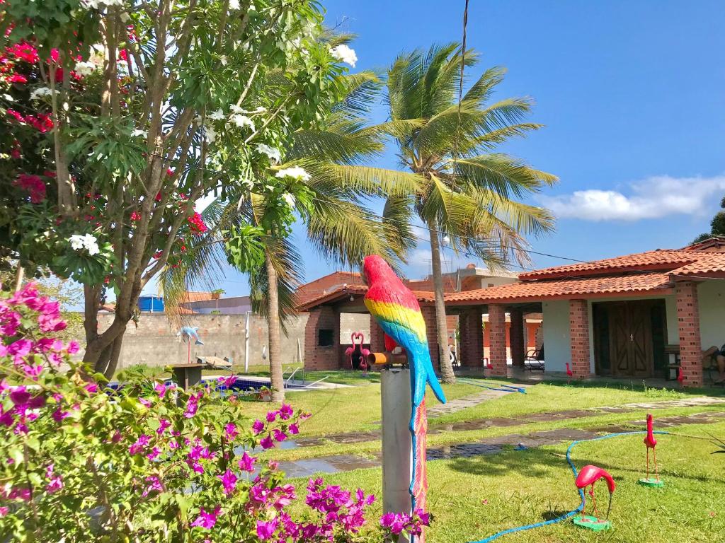 a colorful parrot on a post in a yard at Espaço Billynghan in Barreirinhas