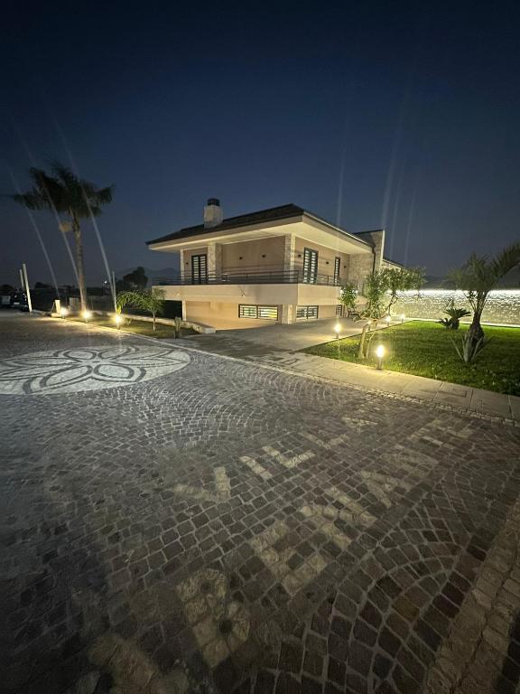 a house with a stone driveway in front of it at Villa Abenante Pompei in Scafati