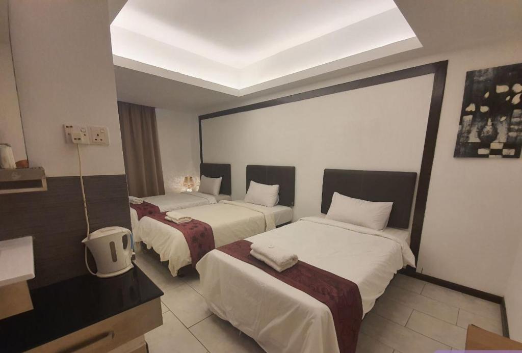 Postel nebo postele na pokoji v ubytování Warisan Hotel Kota Kinabalu