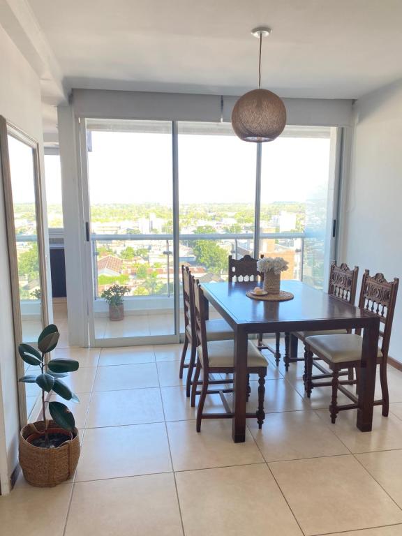 a dining room with a blue table and chairs at Moderno departamento en el centro in Concordia